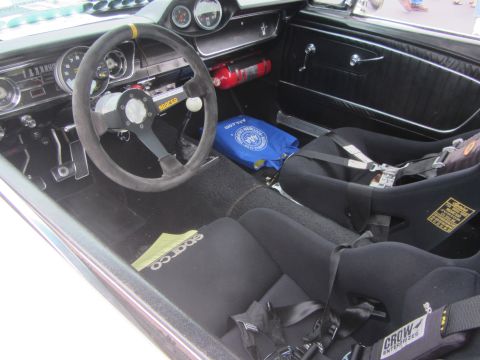 1964 Ford Ranchero - The interior of this 1965 Mustang features racing seats, a Sparco steering wheel, and a fire extinguisher, suggesting a performance-oriente…