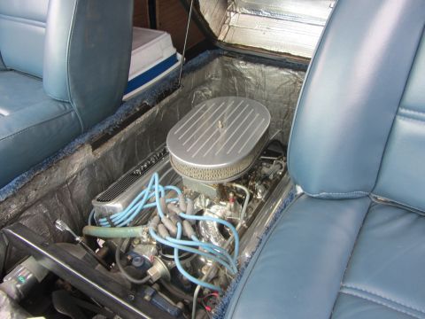 1964 Ford Ranchero - Engine compartment between bucket seats, showing V8 engine and air cleaner assembly.