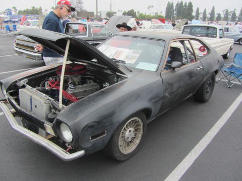 1964 Ford Ranchero - A black Ford Pinto is displayed with its hood open, revealing the engine compartment.