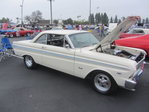 1964 Ford Ranchero - White 1964 Ford Falcon coupe with hood open at a car show, parked next to a red car.