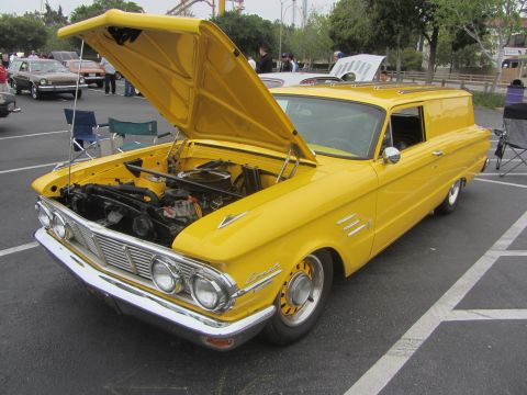 1964 Ford Ranchero - A yellow panel van from the early 1960s is parked with its hood open, revealing the engine bay.
