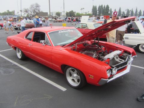 1964 Ford Ranchero - A red 1970 Ford Torino GT is displayed with its hood open at an outdoor car show.