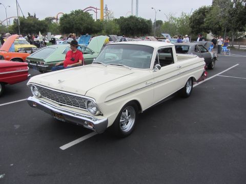 1964 Ford Ranchero - A cream 1964 Ford Ranchero pickup truck is parked at an outdoor event with other vehicles.