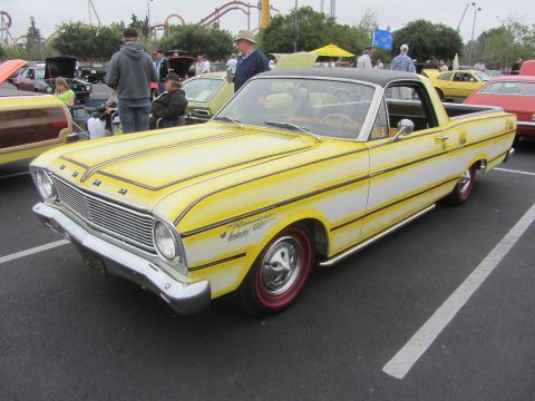 1964 Ford Ranchero - A yellow and white 1964 Ford Ranchero is parked at an outdoor event with other vehicles and people.