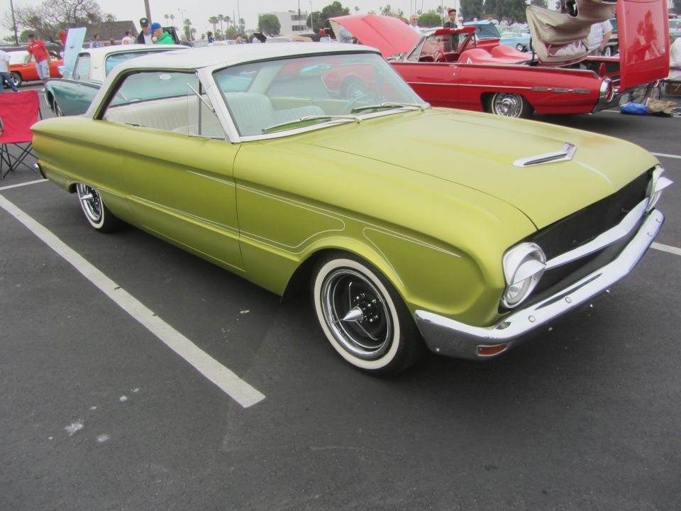 Lime green 1964 Ford Ranchero with a white roof and whitewall tires parked in a lot