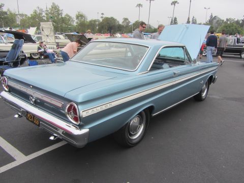 1964 Ford Ranchero - A light blue 1964 Ford Falcon coupe is displayed with its hood open at an outdoor car show.