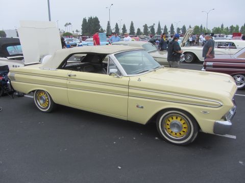 1964 Ford Ranchero - A yellow 1964 Ford Ranchero convertible is parked at an outdoor event with other vehicles present.