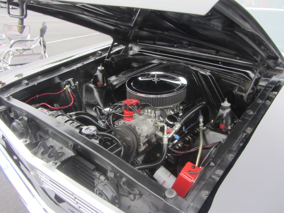 1964 Ford Ranchero engine bay with chrome air cleaner, V8 engine, and red distributor cap