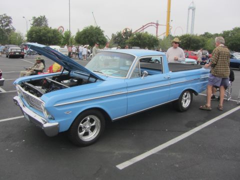 1964 Ford Ranchero - A light blue 1964 Ford Ranchero pickup truck is displayed with its hood up at an outdoor event.