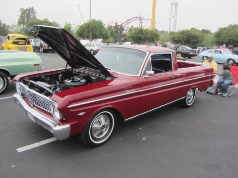1964 Ford Ranchero - A red 1964 Ford Ranchero is displayed with its hood open at an outdoor event.