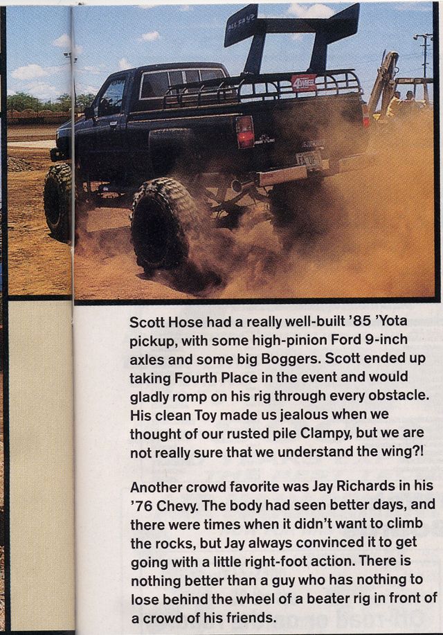 Magazine page of a lifted black '85 Toyota pickup with a rear wing and mud tires kicking up dust