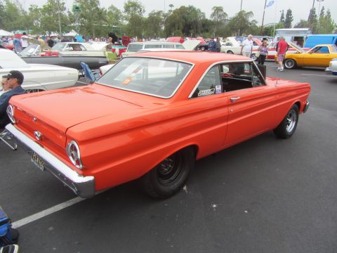 1964 Ford Ranchero - Orange 1964 Ford Ranchero with black wheels at a car show.