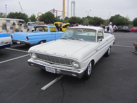1964 Ford Ranchero - A white 1964 Ford Ranchero is parked in a lot with other vehicles visible.