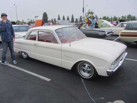 1964 Ford Ranchero - White 1960 Ford Falcon sedan with red interior parked at a car show, other vehicles visible.