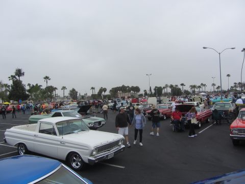 1964 Ford Ranchero - A white 1964 Ford Ranchero is among many classic vehicles at an outdoor gathering.