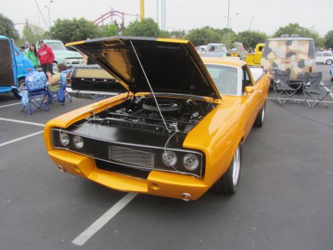 1964 Ford Ranchero - Front view of a modified 1970 Dodge Charger at a car show, hood up revealing the engine.