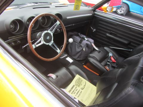 1964 Ford Ranchero - Interior view of a classic car, possibly a 1969 model, with a large steering wheel and black bucket seats.