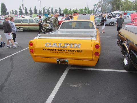 1964 Ford Ranchero - A yellow 1964 Ford Ranchero pickup truck is parked at an outdoor event, displaying 'Galpin Classic Auto Service' on its tailgate.