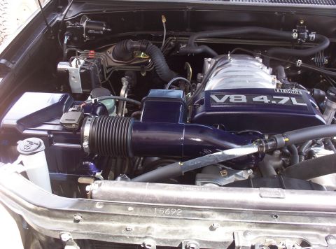 1988 Ford Bronco - Engine bay features a V8 4.7L engine cover and dark blue intake piping.