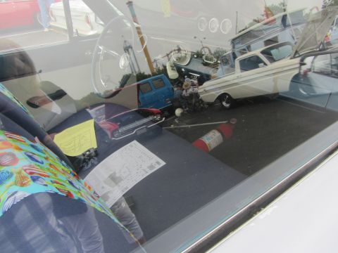 1964 Ford Ranchero - Interior view of a 1964 Ford Ranchero, with reflections of other vehicles visible through the windshield.
