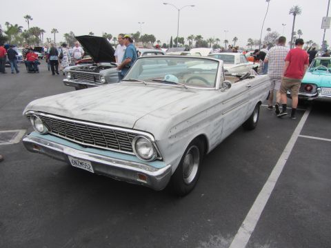 1964 Ford Ranchero - A primer-finished 1964 Ford Falcon convertible is displayed at a car show with other vehicles.