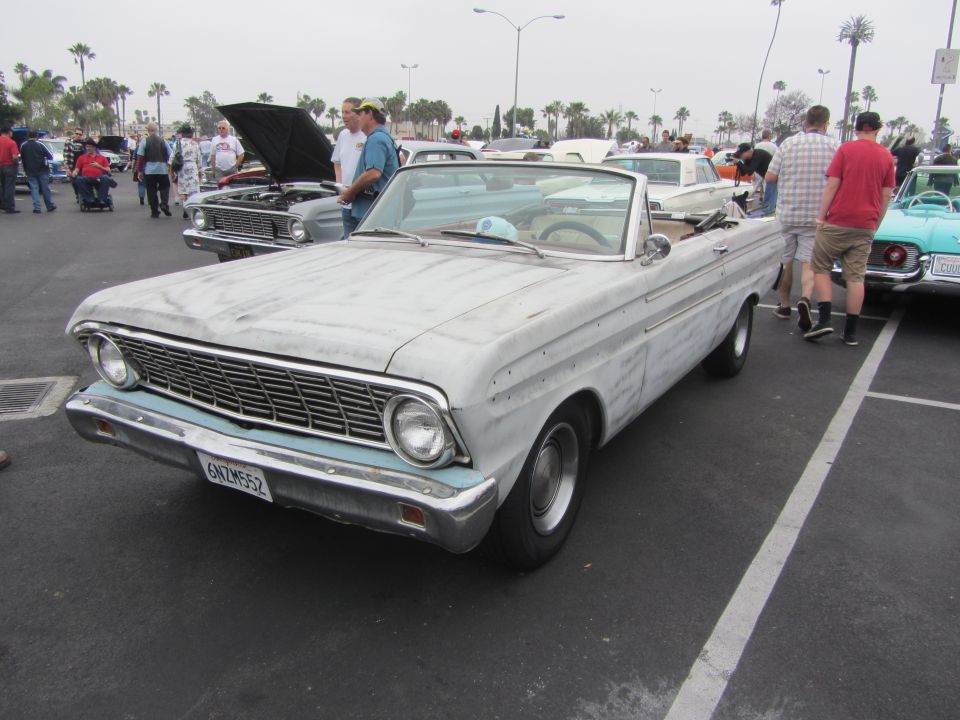 1964 Ford Falcon convertible with primer finish, parked at an outdoor car show