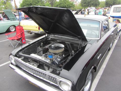 1964 Ford Ranchero - Black 1963 Ford Falcon Ranchero with hood open, revealing its engine and chrome grille.