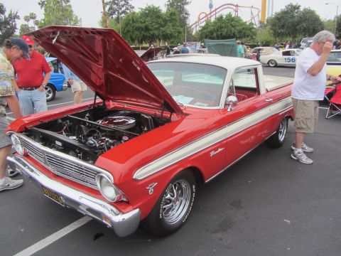 1964 Ford Ranchero - A red and white 1964 Ford Ranchero is displayed with its hood open at an outdoor car show.