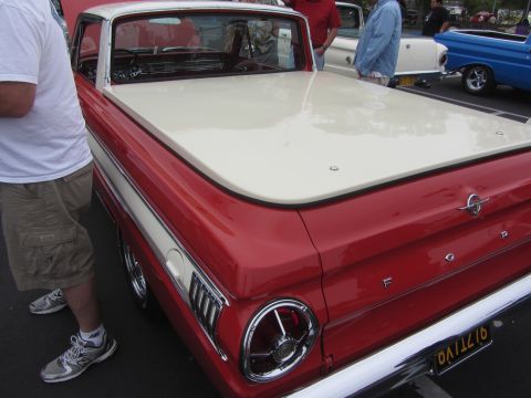 1964 Ford Ranchero - Rear view of a red and white 1964 Ford Ranchero pickup truck with chrome accents and a California license plate.