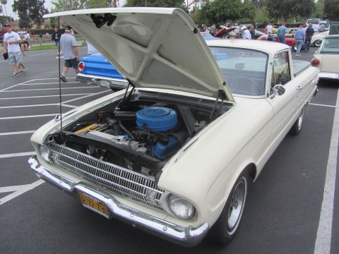 1964 Ford Ranchero - 1964 Ford Ranchero's engine bay is visible with the hood open.