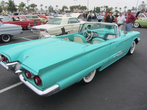 1964 Ford Ranchero - A turquoise 1959 Ford Thunderbird convertible is parked at an outdoor event with other classic cars visible.