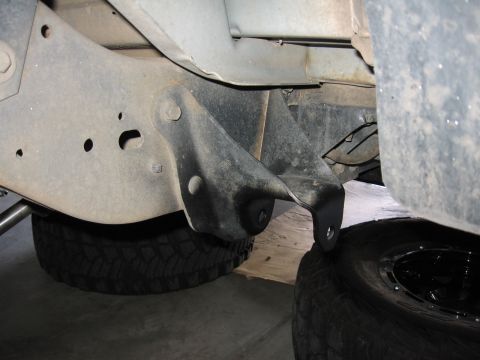 1995 Ford Bronco - Undercarriage view showing frame, suspension bracket, and tires.