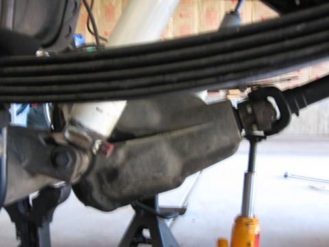 1995 Ford Bronco - Vehicle's rear axle assembly with leaf springs and driveshaft components visible.