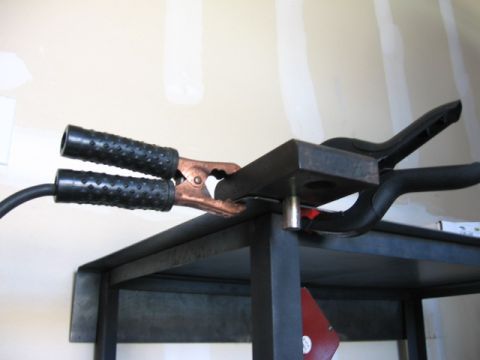 1995 Ford Bronco - Welding clamps are attached to a metal shelf, ready for use.