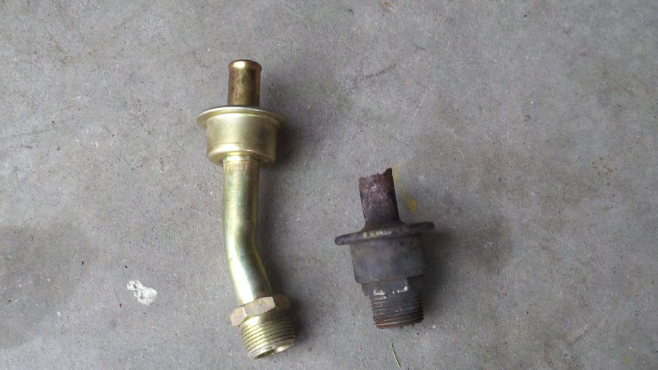 Two metal pipe fittings, one bent and brass-colored, the other dark and broken