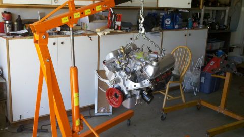 1978 Ford Bronco - Engine hoist lifting a V8 engine, likely for rebuild or installation.
