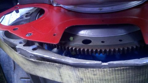 1978 Ford Bronco - Detail shot of a vehicle's engine flywheel and starter gear assembly.