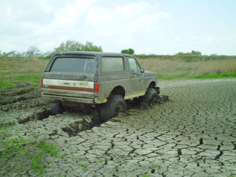 1990 Ford Bronco - This 1990 Ford Bronco is deeply stuck in cracked, dry mud.