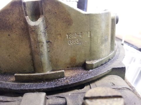 1968 Ford Mustang - Carburetor part with stamped identification numbers visible.
