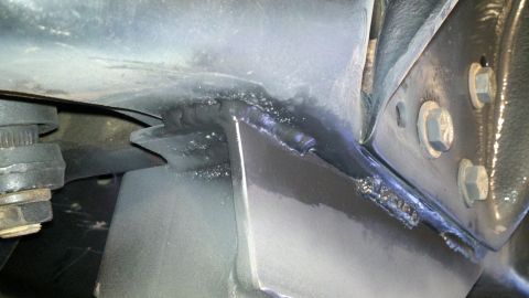 1995 Ford Bronco - Close-up view of a welded metal frame section, likely from a vehicle's steering or suspension system.