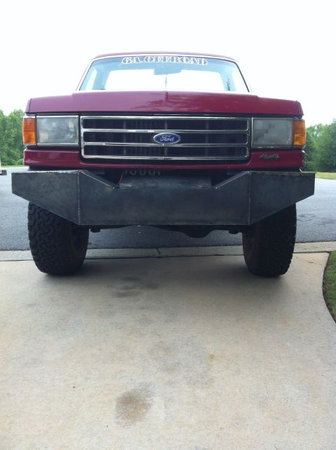 1989 Ford Bronco - This Ford truck features a custom bumper and a banner on the windshield.