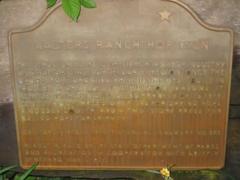2002 Ford Taurus - A weathered cast-bronze historical marker mounted on wood siding, titled "Walters Ranch Hop Kiln" and describing the 1905 stone hop-drying…