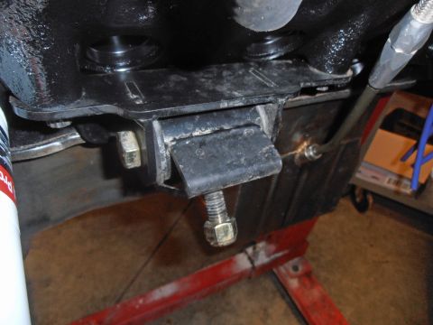 1990 Ford Bronco - This is a close-up view of a vehicle's engine mount, showing its construction and attachment points.