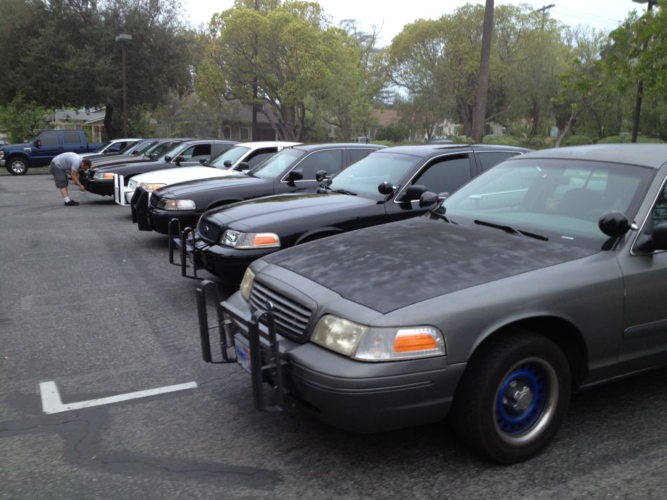 Gray 2004 Ford Crown Victoria police car with blue wheel rims and push bumper