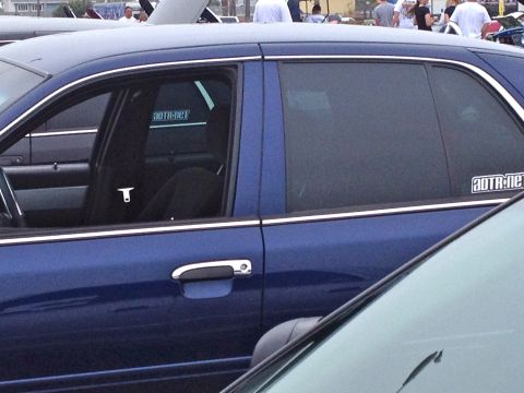 2004 Ford Crown Victoria - A blue sedan is parked at an outdoor car event with other vehicles visible.