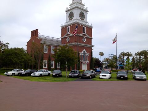 2004 Ford Crown Victoria - Multiple Ford Crown Victorias are parked on the lawn in front of a building resembling Independence Hall.