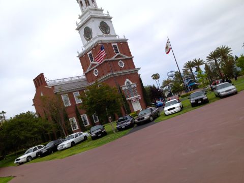 2004 Ford Crown Victoria - A lineup of Ford Crown Victoria Police Interceptors is displayed in front of a historic building.