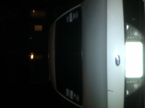 2000 Ford Crown Victoria - A white 2000 Ford Crown Victoria is viewed from the front three-quarter angle, with a watermark visible at the bottom right.