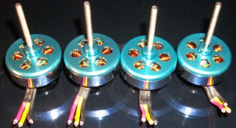 1996 Ford Bronco - A set of four teal electric motors, each with a silver threaded shaft and three colored wires extending from the base.