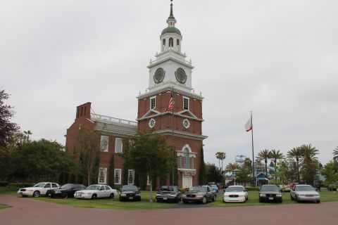 2004 Ford Crown Victoria - A lineup of Ford Crown Victoria police sedans is parked on a lawn in front of a historic-looking building.